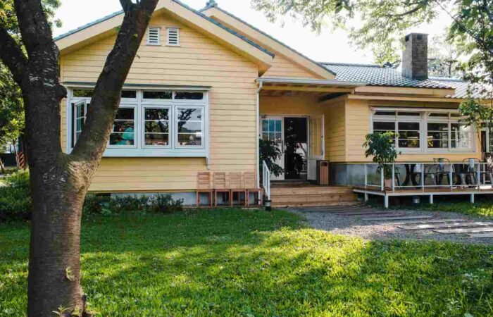 a house with yellow exterior cladding - recladding a house auckland