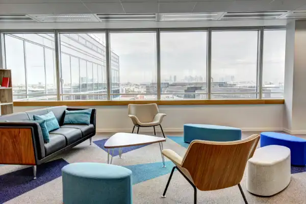 modern office lounge area with a couch and stools